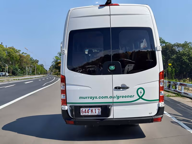 Image of a Murrays Electric Vehicle driving on the road.